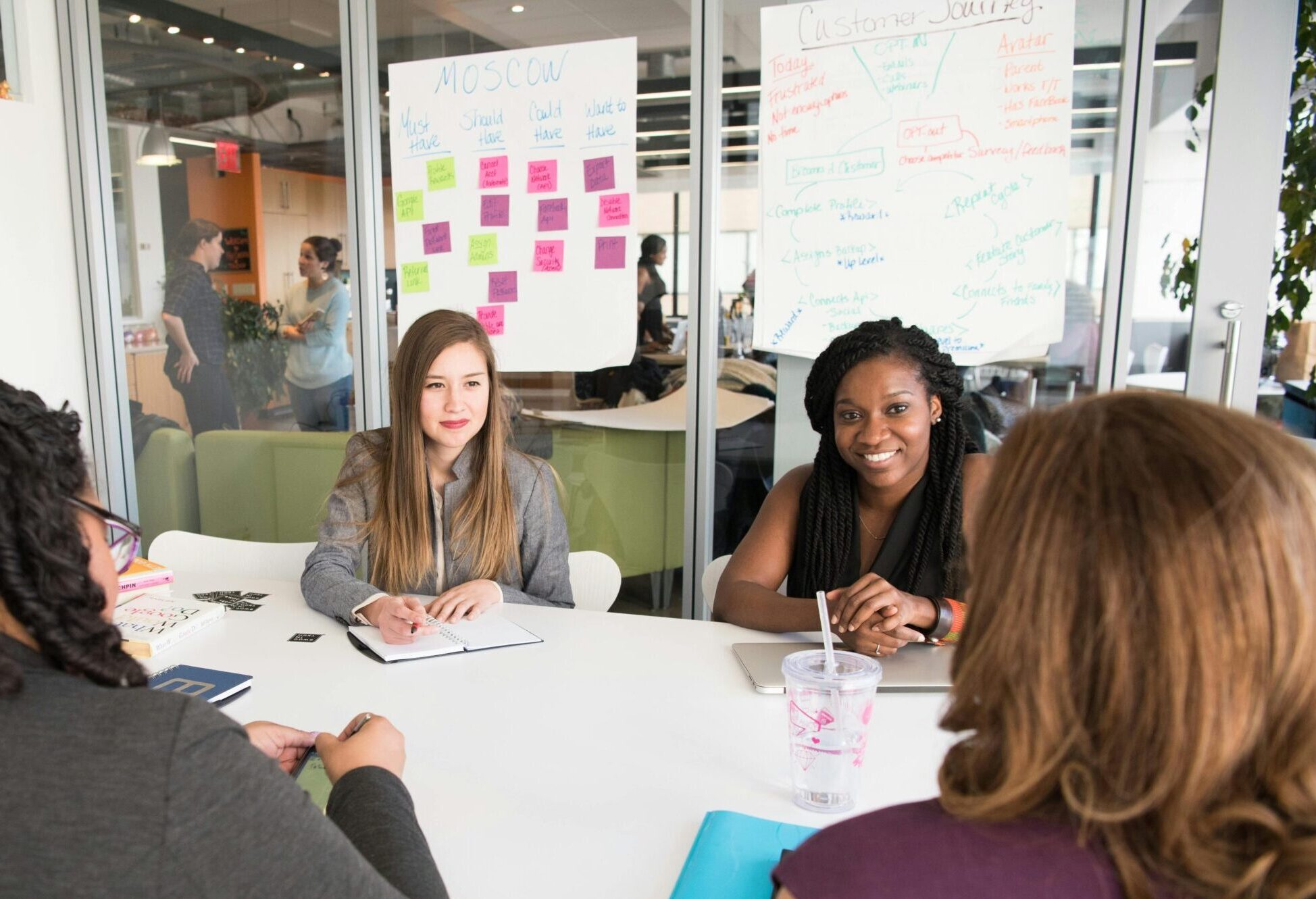 Women sitting together around a table. Stock photo describing a professional workshop.